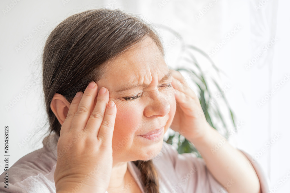diseased mature woman experiences severe headache, holding head, Hot flashes during menopause, Decreased memory and concentration, feeling nervous, Feeling tired, exhausted, menopause, midlife crisis diseased mature woman experiences severe headache, holding head, Hot flashes during menopause, Decreased memory and concentration, feeling nervous, Feeling tired, exhausted, menopause, midlife crisis