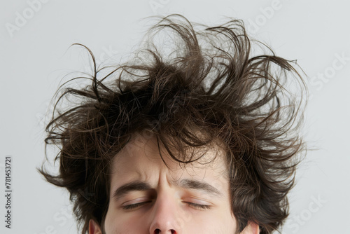 Close-up photo of a young man's messy bedhead, expressing a carefree attitude photo