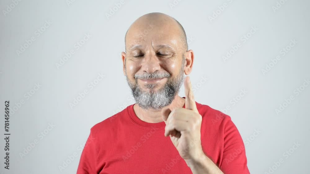 Serious bald bearded man in red shirt making surprise gesture and thumbs up sign. Serious bald bearded man in red shirt making surprise gesture and thumbs up sign.
