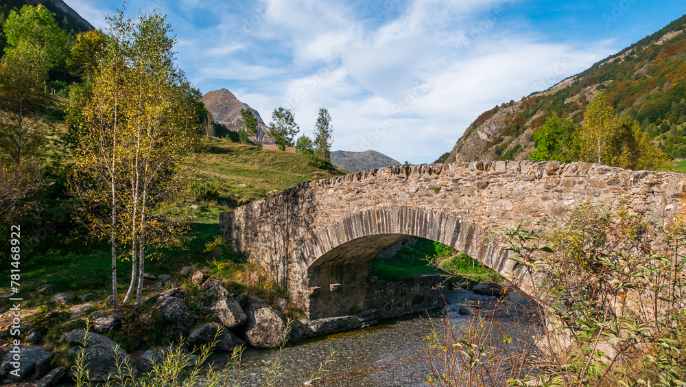 Gavarnie, Hautes-Pyrénées, France - October 13, 2023: Medieval stone bridge over the Gave de Gavarnie river