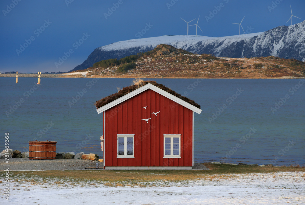 Winter landscape with red boathouse near Alesund, Norway.