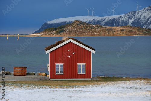 Fototapeta Winter landscape with red boathouse near Alesund, Norway.