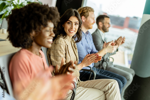 Energetic applause by a diverse group at a casual indoor event