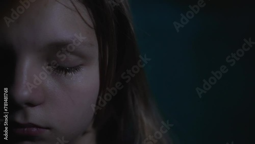 Crying girl in a dark place photo