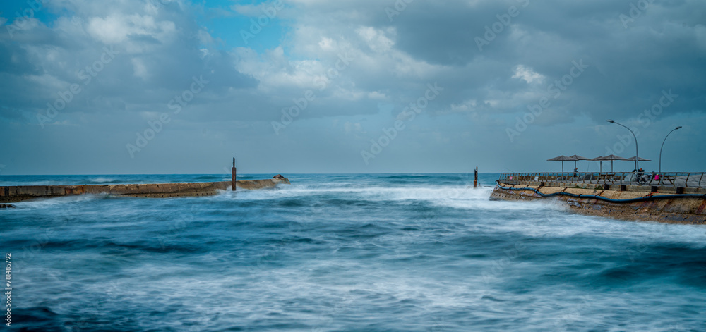 Picturesque coastal scene featuring a serene sea shore with soft, billowing clouds