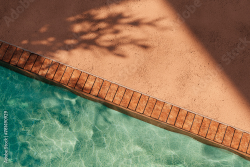 Top view of orange poolside in luxury hotel villa with sunlight shadow and swimming pool. Summer tropical background for product placement podium mockup.