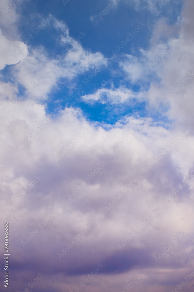 Transition of a cloud from white to rainy in the blue sky, vertical shot Transition of a cloud from white to rainy in the blue sky, vertical shot