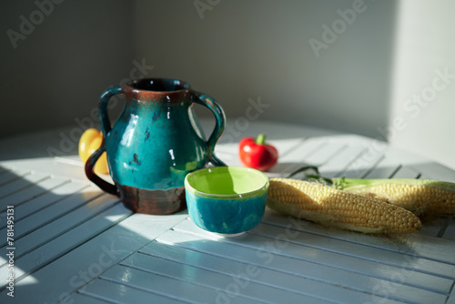 Still life with corn, pear, pepper and an old ceramic jug. Healthy eating concept. High quality photo