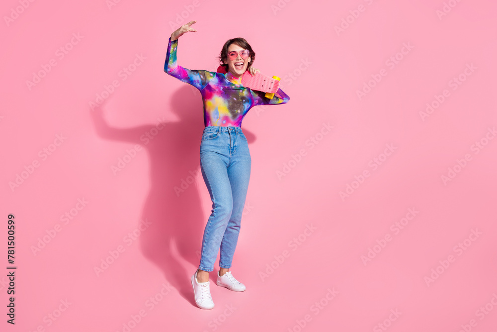 Full size photo of nice young woman skateboard dance empty space wear pullover isolated on pink color background