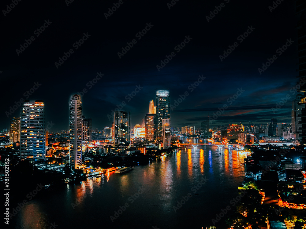 Beautiful architecture in Bangkok City skyline at night Filter effect Chao Phraya riverside at night, office buildings, Cityscape, night view in the business district at twilight capital of Thailand.