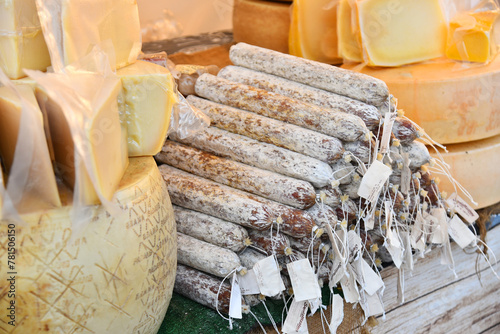 Farm stall with cheese wheels and smoked sausage at the fair