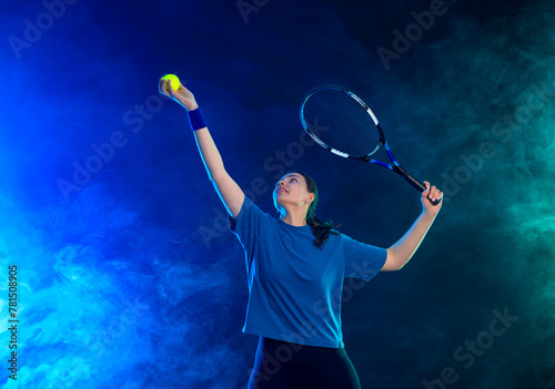 Tennis player woman with racket on tournament. Girl athlete with racket on open court with neon colors. Download a high quality photo for design of a sports app or tour events. © Mike Orlov