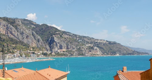 Serene Seaside Town at Midday With Clear Blue Skies and Tranquil Waters
