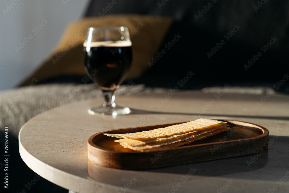 Fototapeta premium Potato chips and glass with beer on background