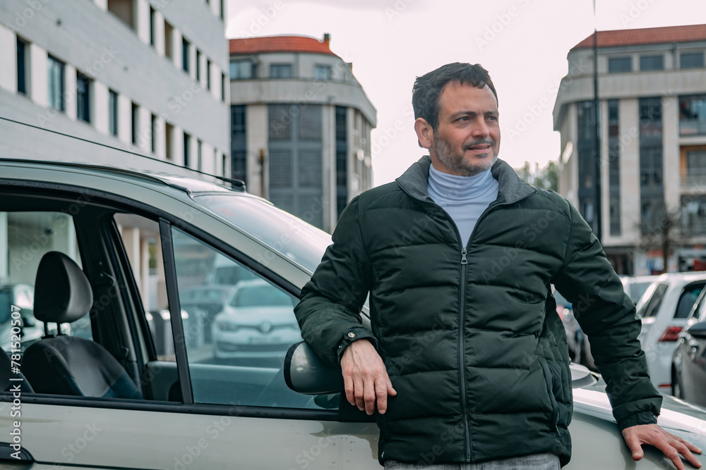 middle aged man leaning in front of car middle aged man leaning in front of car