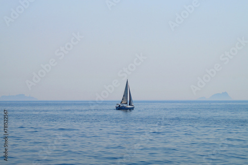 small sailing yacht at sea against the background of the sea horizon