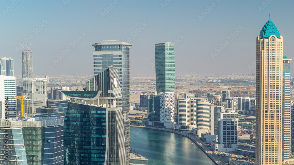 Aerial skyline of Dubai's business bay with skyscrapers timelapse before sunset.