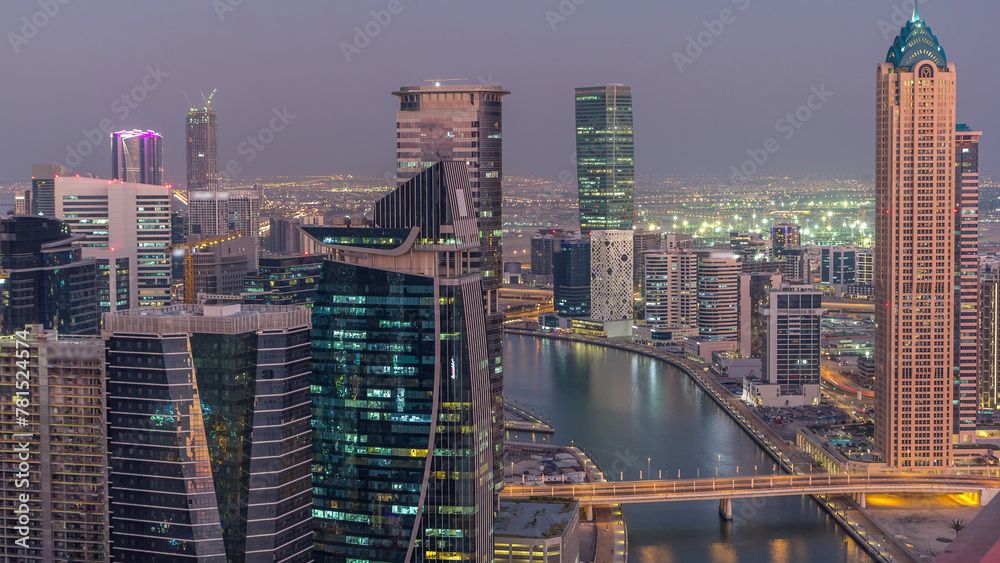 Aerial skyline of Dubai's business bay with skyscrapers day to night timelapse