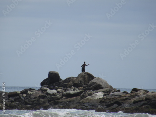 fisherman in rocks, La Guaira, Venezuela photo