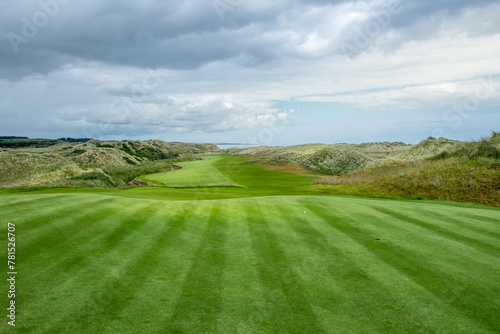 An hilly golf course facing the sea in Scotland photo