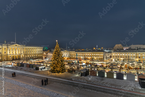 Shopping at the illuminated Christmas Market in the Helsinki Senate Square photo