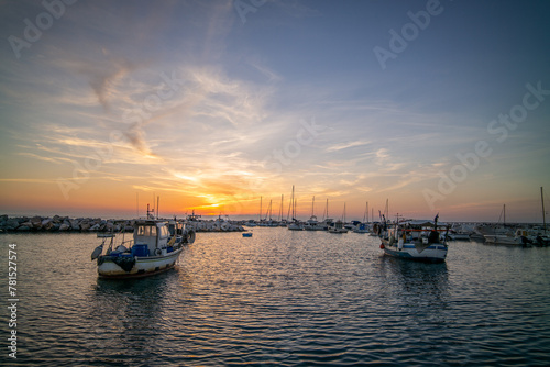 Colorful fishing boats on the Tuscan coast in autumn at sunset