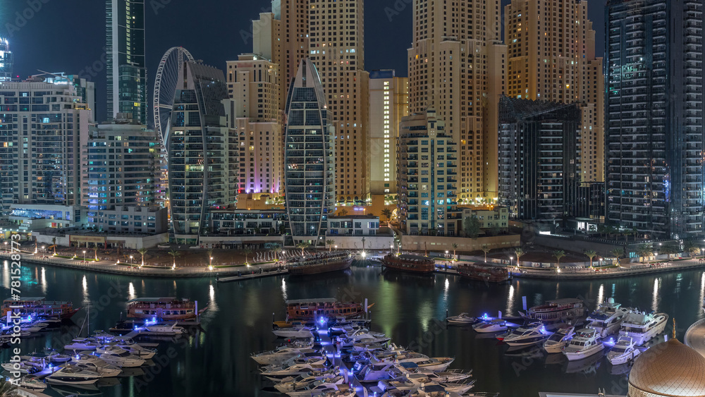 Luxury yachts parked on the pier in Dubai Marina bay with city aerial view night to day timelapse