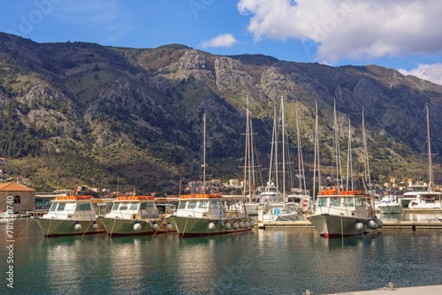 Boats and sailboats in port near Old Town of Kotor. Beautiful Mediterranean landscape. Montenegro, Adriatic Sea, Bay of Kotor