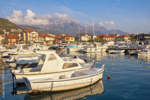 Fishing boats in harbor. Beautiful Mediterranean landscape. Montenegro, Tivat city.  View of Marina Kalimanj on sunny spring day