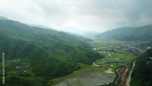 Rice field aerial shot at north east of India. 4k aerial views of beautiful mountain small house and rice terraces field at kangpokpi village rice terraces with senapati river near mayangkhang baptist photo