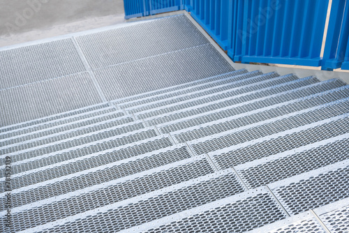 New staircase with perforated steps made from metal iron. Industrial background