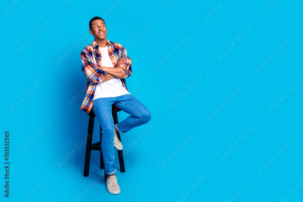 Full size photo of nice young man look empty space wear shirt isolated on blue color background