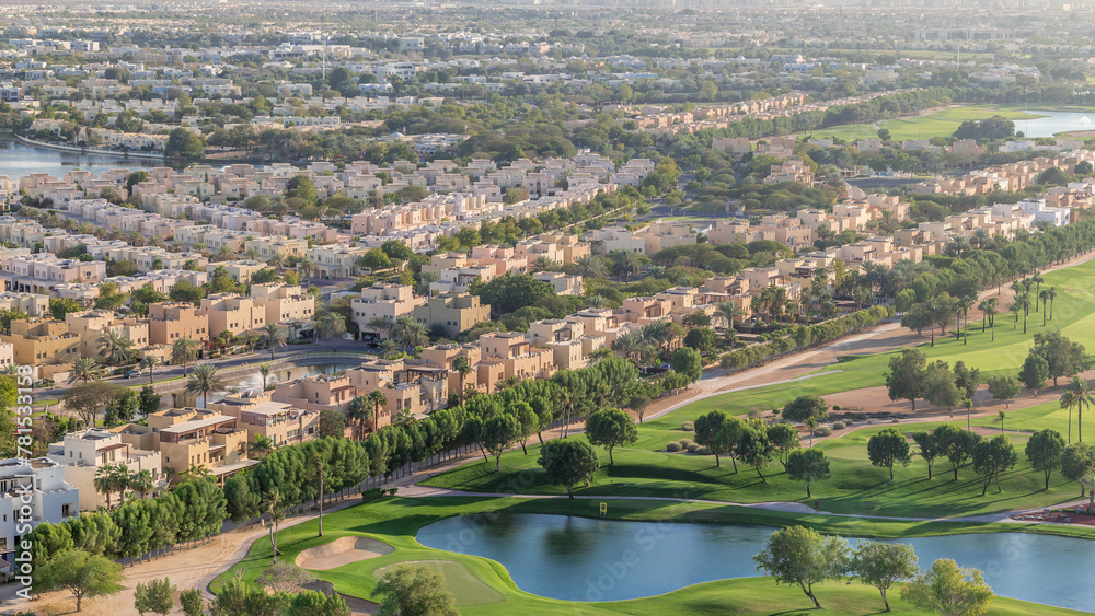 Aerial view to villas and houses with Golf course with green lawn and lakes timelapse Aerial view to villas and houses with Golf course with green lawn and lakes timelapse