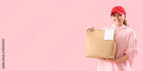 Female courier with paper bag on pink background