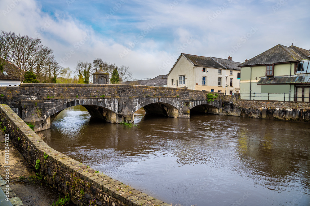 A view along the south bank towards the old bridge on the River Cleddau in Haverfordwest, Pembrokeshire, Wales on a spring day