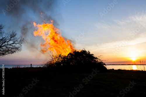 walpurgis eve celebration Sweden flames agianst sunset ocean horizon