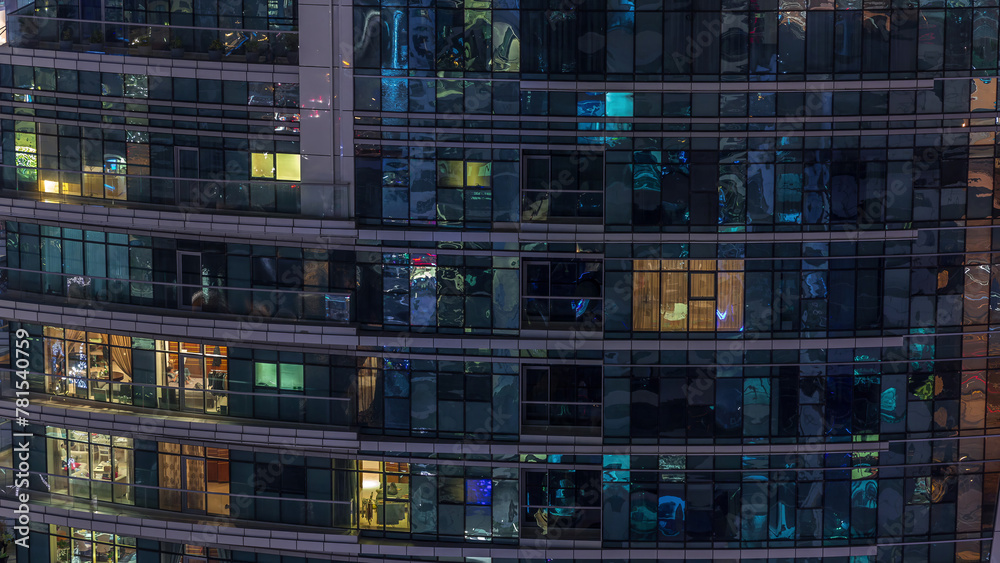 Rows of glowing windows with people in apartment building at night. Rows of glowing windows with people in apartment building at night.