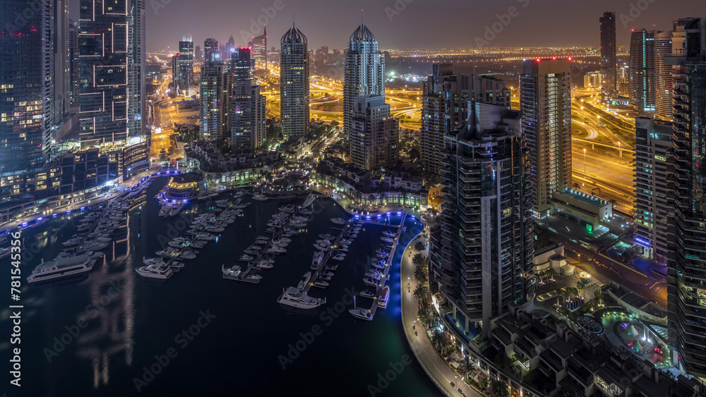 Aerial top view of Dubai Marina night to day timelapse. Modern towers and traffic on the road