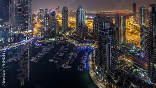 Aerial top view of Dubai Marina night to day timelapse. Modern towers and traffic on the road
