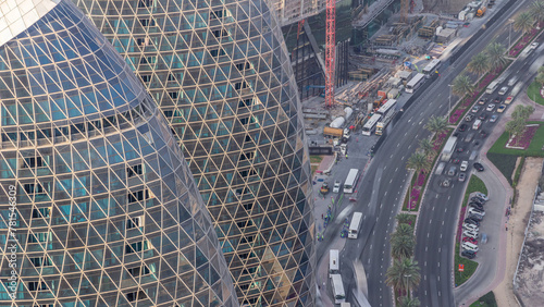 Skyline view of intersection traffic on Al Saada street near DIFC timelapse in Dubai, UAE. photo