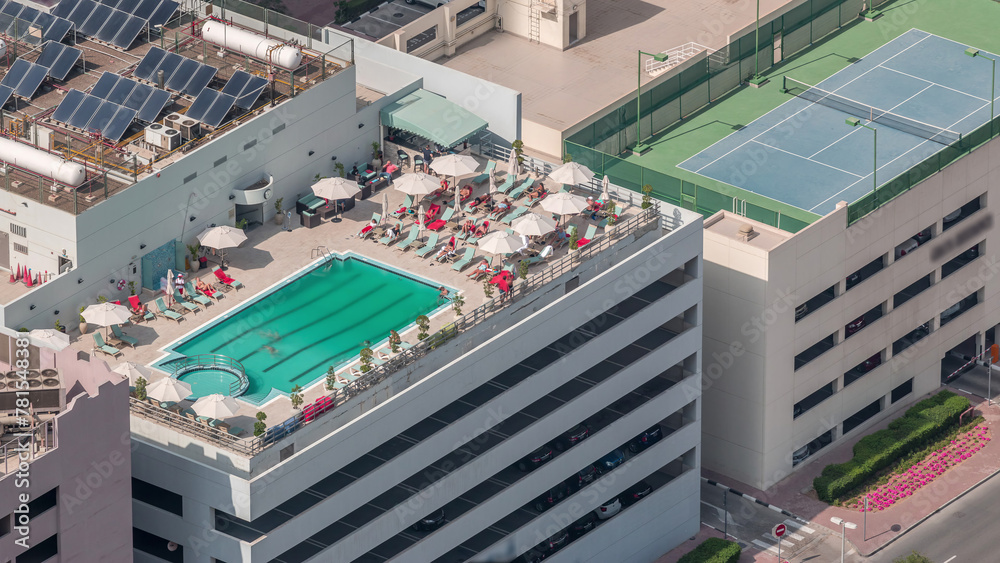Car parking lot with rooftop swimming pool viewed from above timelapse, Aerial top view. Dubai, UAE Car parking lot with rooftop swimming pool viewed from above timelapse, Aerial top view. Dubai, UAE
