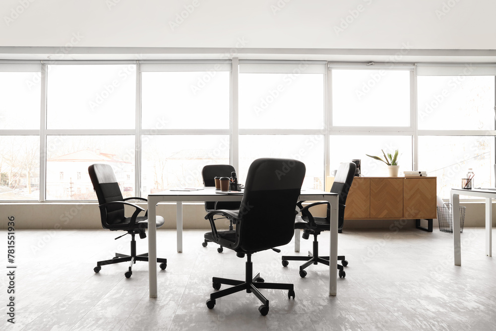 Interior of modern conference hall with window, chest of drawers, table and armchairs Interior of modern conference hall with window, chest of drawers, table and armchairs