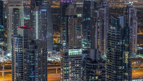 Dubai Marina skyscrapers and jumeirah lake towers view from the top aerial night timelapse in the United Arab Emirates. © neiezhmakov