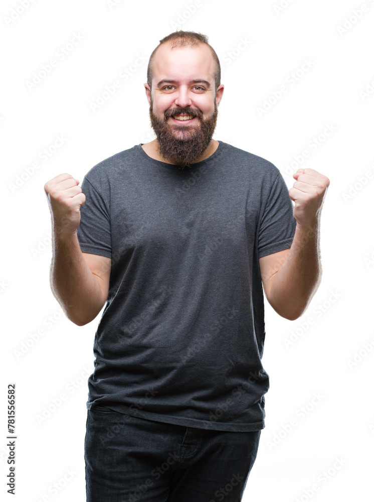 Young caucasian hipster man over isolated background celebrating surprised and amazed for success with arms raised and open eyes. Winner concept. Young caucasian hipster man over isolated background celebrating surprised and amazed for success with arms raised and open eyes. Winner concept.