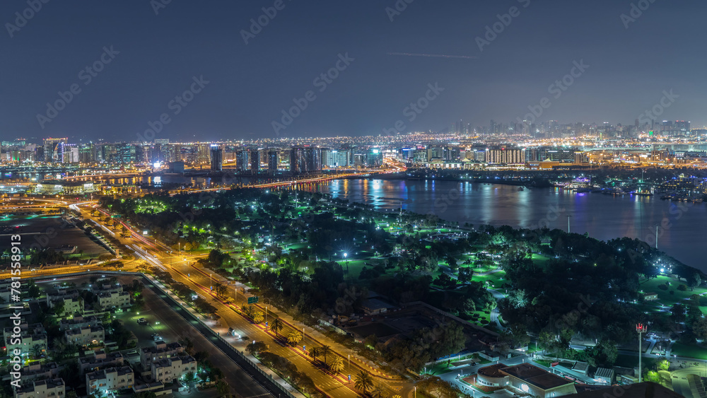 Fototapeta premium Nighttime rhythm of the city of Dubai near canal aerial timelapse