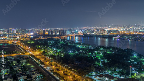 Nighttime rhythm of the city of Dubai near canal aerial timelapse