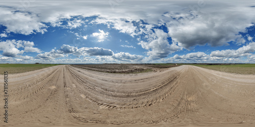 blue sky hdri 360 panorama with awesome clouds on gravel road among fields in spring day in equirectangular full seamless spherical projection, for VR AR content or skydome replacement