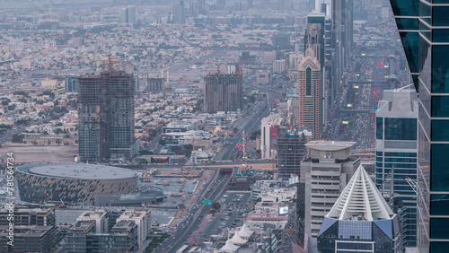 Skyscrapers on Sheikh Zayed Road and DIFC aerial day to night timelapse in Dubai, UAE.