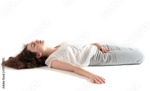 Brunette Woman Sleeping concept. White shirt and jeans. Eyes closed. Laying on the isolated white background. Can also represent Fainted, dead, relaxed, relaxation, drunk.