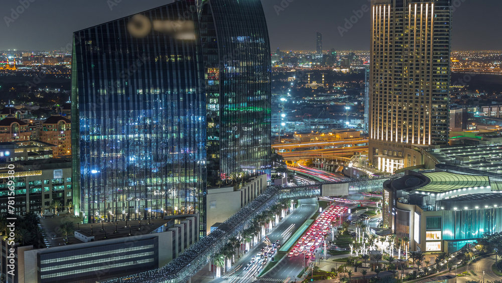 Dubai downtown street with busy traffic and skyscrapers around night timelapse.